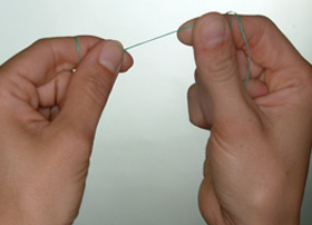 Break off about 18 inches of floss and wind most of it around your middle or index finger. Wind the rest of the floss around a finger of the other hand. This finger will take up the used floss.